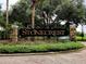 Stonecrest entrance sign with brick pillars and wrought iron fence surrounded by trees at 17808 Se 115Th Ct, Summerfield, FL 34491