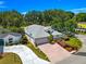Charming single-story home with a brick driveway, attached garage, and landscaped front yard at 17808 Se 115Th Ct, Summerfield, FL 34491