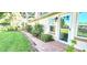 Charming home entrance with a brick pathway and lush landscaping at 17808 Se 115Th Ct, Summerfield, FL 34491