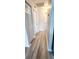 Hallway with wood floors, white trim, neutral colored walls, and lots of closet space at 17808 Se 115Th Ct, Summerfield, FL 34491