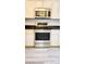 Modern kitchen featuring stainless steel range and microwave at 17808 Se 115Th Ct, Summerfield, FL 34491