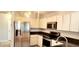 Cozy kitchen featuring granite counters, stainless steel appliances, and bright, white cabinets at 17808 Se 115Th Ct, Summerfield, FL 34491