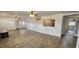 Bright living room featuring tile floors, ceiling fans, and plenty of space for entertaining at 17808 Se 115Th Ct, Summerfield, FL 34491