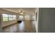 Spacious living room with large windows providing natural light, and ceiling fans for comfort at 17808 Se 115Th Ct, Summerfield, FL 34491