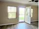Inviting room with vinyl plank flooring and view to exterior at 17808 Se 115Th Ct, Summerfield, FL 34491