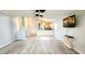 Open living room with wood floors connecting to the kitchen at 17808 Se 115Th Ct, Summerfield, FL 34491