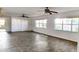 Bright living room featuring tile floors, multiple windows for natural light, and ceiling fans at 17808 Se 115Th Ct, Summerfield, FL 34491