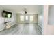 Spacious living room with gray wood floors and modern ceiling fan at 17808 Se 115Th Ct, Summerfield, FL 34491
