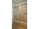 Shower over tub featuring sliding glass door at 17808 Se 115Th Ct, Summerfield, FL 34491