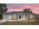 Home's exterior shows stylish front door, modern colors, manicured lawn, and updated windows at 3694 Sw 149 Ter, Ocala, FL 34481