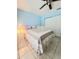 Cozy bedroom with a ceiling fan, bed with a decorative coverlet, and closet with sliding doors at 5650 Se 34Th St, Ocala, FL 34480