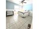 Bedroom with a ceiling fan, bed with a decorative coverlet, and a baby changing station at 5650 Se 34Th St, Ocala, FL 34480