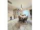 Dining area featuring a table with four chairs, a china cabinet, and a large window at 5650 Se 34Th St, Ocala, FL 34480