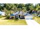 Charming single-story home with a well-maintained lawn, mature trees, and an attached two-car garage at 5650 Se 34Th St, Ocala, FL 34480