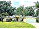 Charming single-story home featuring a manicured lawn, a two-car garage, and mature trees at 5650 Se 34Th St, Ocala, FL 34480