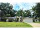 Charming single-story home featuring a manicured lawn, a two-car garage, and mature palm trees at 5650 Se 34Th St, Ocala, FL 34480