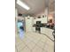 Open kitchen with white cabinets, tile floors, and stainless steel appliances at 5650 Se 34Th St, Ocala, FL 34480