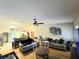 Open concept living room featuring hardwood floors and a ceiling fan, perfect for entertaining at 5650 Se 34Th St, Ocala, FL 34480