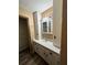 Bathroom with a vanity, built-in storage, and a well-lit mirror with a neutral palette at 5877 Nw 64Th St, Ocala, FL 34482