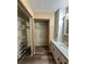 Bathroom vanity with storage and a nearby closet with metal shelving, plus wood-look floors at 5877 Nw 64Th St, Ocala, FL 34482