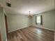 Bedroom with wood-look floors, a chandelier, closet, and window for lots of natural light at 5877 Nw 64Th St, Ocala, FL 34482