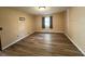 A tranquil bedroom showcasing wood-look floors and a bright window for ample natural light at 5877 Nw 64Th St, Ocala, FL 34482
