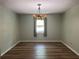 Bedroom with wood-look floors, a chandelier, closet, and window for lots of natural light at 5877 Nw 64Th St, Ocala, FL 34482