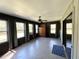 Spacious sun room with brick walls, ceiling fan, windows and sliding door access at 5877 Nw 64Th St, Ocala, FL 34482