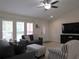 Living room with gray sofas, ottoman, and large TV at 22 Juniper Pass Crse, Ocala, FL 34480