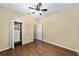 Bedroom showcases a ceiling fan and closet with shelving for ample storage at 11017 Sw 71St Cir, Ocala, FL 34476