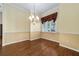 Dining room with hardwood floors, decorative chandelier and large window at 11017 Sw 71St Cir, Ocala, FL 34476