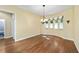 Bright dining area with hardwood floors, chandelier, and sunny windows at 11017 Sw 71St Cir, Ocala, FL 34476