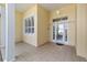 Covered front porch with tile flooring and a decorative glass front door at 11017 Sw 71St Cir, Ocala, FL 34476