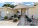 Exterior front entry features a covered porch and elegant glass front door at 11017 Sw 71St Cir, Ocala, FL 34476