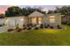 Beautiful single-story home with manicured front yard, mature trees, and welcoming facade at sunset at 11017 Sw 71St Cir, Ocala, FL 34476