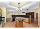 Bright kitchen featuring wood cabinets, granite countertops, a center island, and sleek black appliances at 11017 Sw 71St Cir, Ocala, FL 34476