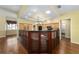 Spacious kitchen with hardwood floors, tray ceiling, wood cabinets, and stainless steel appliances at 11017 Sw 71St Cir, Ocala, FL 34476