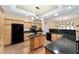 Well-lit kitchen with granite countertops, wood cabinets, a central island, and modern appliances at 11017 Sw 71St Cir, Ocala, FL 34476