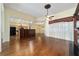Open concept living area with hardwood floors that flows into the kitchen and dining room at 11017 Sw 71St Cir, Ocala, FL 34476