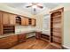 Home office with custom built-ins, ample storage, a built-in desk, and hardwood floors at 11017 Sw 71St Cir, Ocala, FL 34476