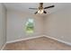 Bedroom with a ceiling fan, window, neutral paint, and neutral carpeting at 4519 Sw 111Th Pl, Ocala, FL 34476