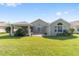 Well-maintained backyard with a screen porch, grassy area, and charming architectural details at 7173 Sw 113Th Loop, Ocala, FL 34476