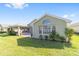 Lush green backyard with a screened in porch, patio, and ample sunlight at 7173 Sw 113Th Loop, Ocala, FL 34476