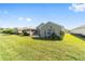Lush green backyard featuring a screened porch and pretty landscaping on a sunny day at 7173 Sw 113Th Loop, Ocala, FL 34476