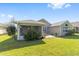 Expansive backyard featuring a screened porch, well-kept lawn, and beautiful landscaping at 7173 Sw 113Th Loop, Ocala, FL 34476