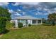 Beautiful home with a spacious backyard featuring a screened-in lanai and lush green lawn at 15268 Sw 14Th Avenue Rd, Ocala, FL 34473