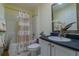 Cozy bathroom featuring a shower-tub combo with a curtain, vanity with storage, and decorative mirror at 15268 Sw 14Th Avenue Rd, Ocala, FL 34473