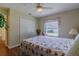 This bedroom features neutral walls, wood floors, a double closet and a window overlooking the yard at 15268 Sw 14Th Avenue Rd, Ocala, FL 34473