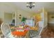 A glass table with seating for four is set near a sunny living room and kitchen at 15268 Sw 14Th Avenue Rd, Ocala, FL 34473