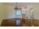 Cozy dining room with hardwood floors, ornate chandelier, and ample natural light, perfect for intimate gatherings at 15268 Sw 14Th Avenue Rd, Ocala, FL 34473